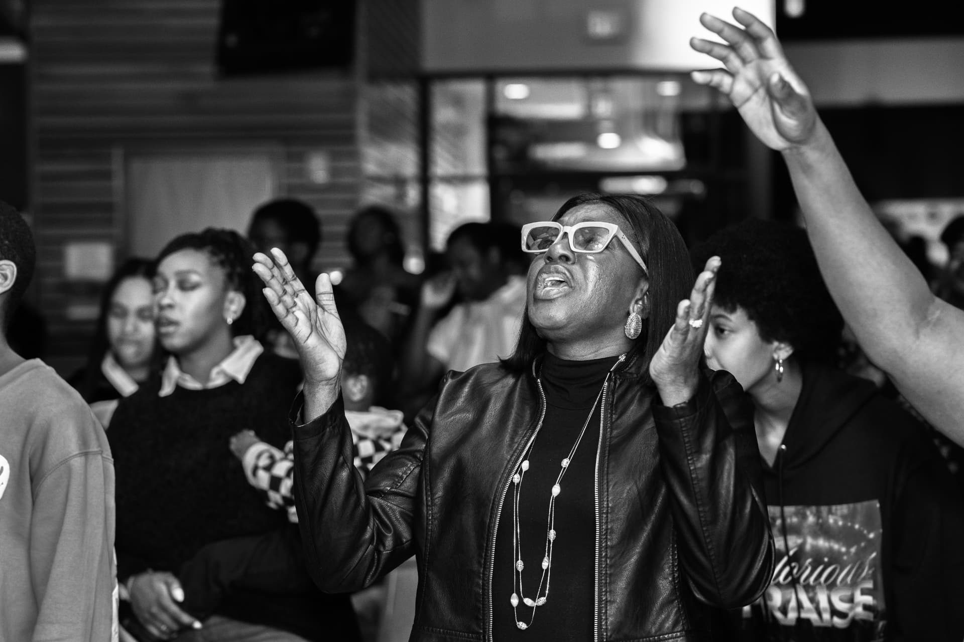 A woman lifting her hands in worship at Glorious Praise